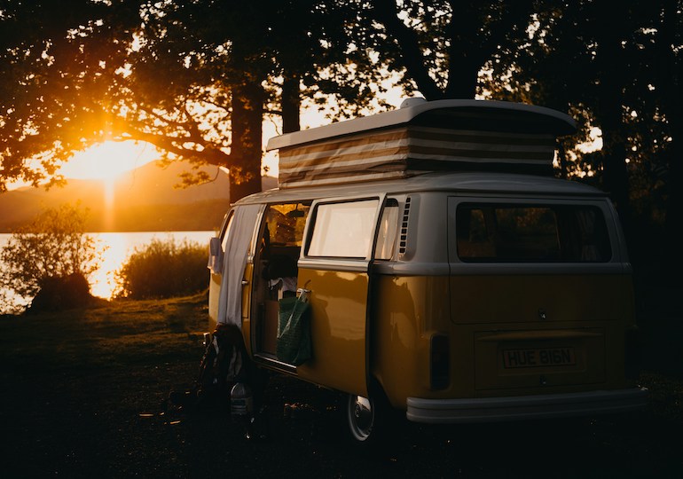 A campervan parked up by a loch