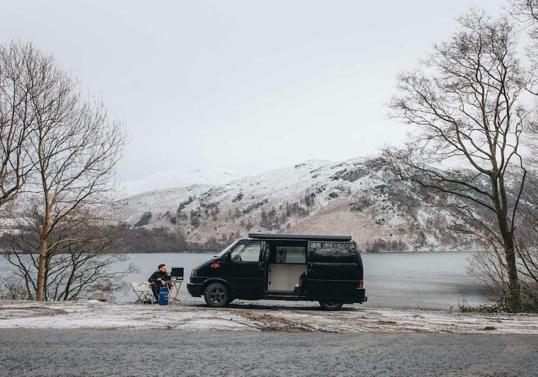 A campervan parked up in a wintry setting