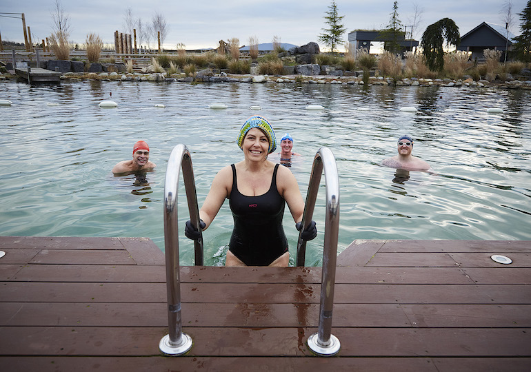 A woman getting into a pool